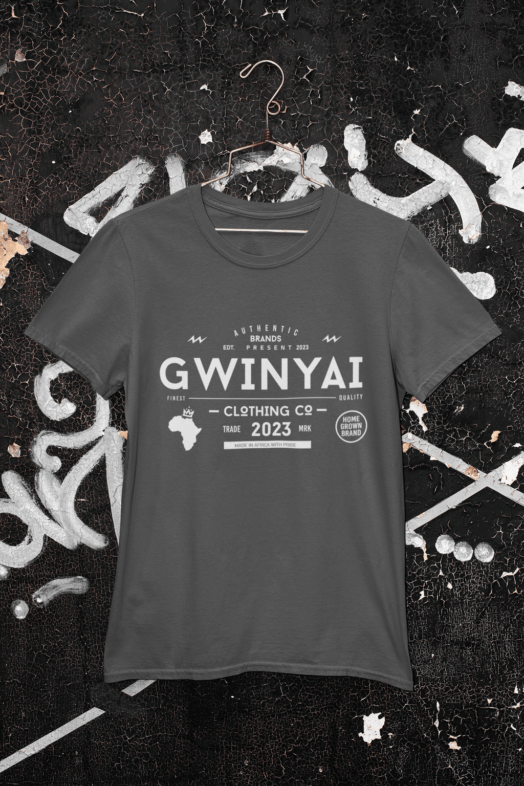 Gwinyai T-shirts displayed on a hanger against a graffiti background, showcasing bold African-inspired design.