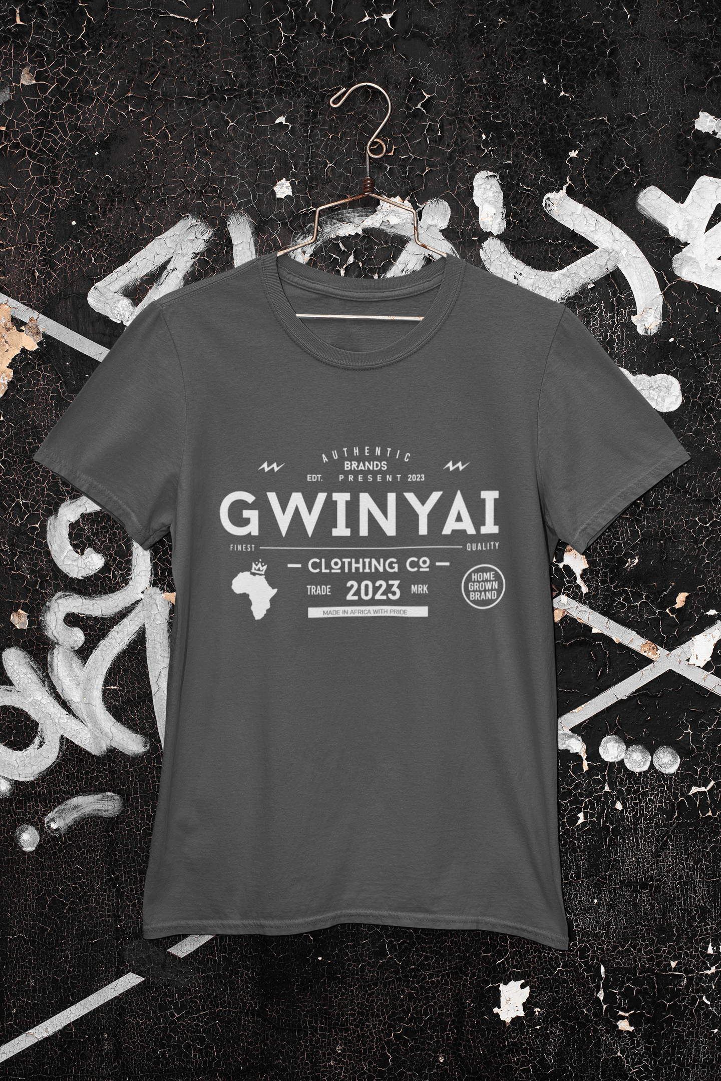 Gwinyai T-shirts displayed on a hanger against a graffiti background, showcasing bold African-inspired design.